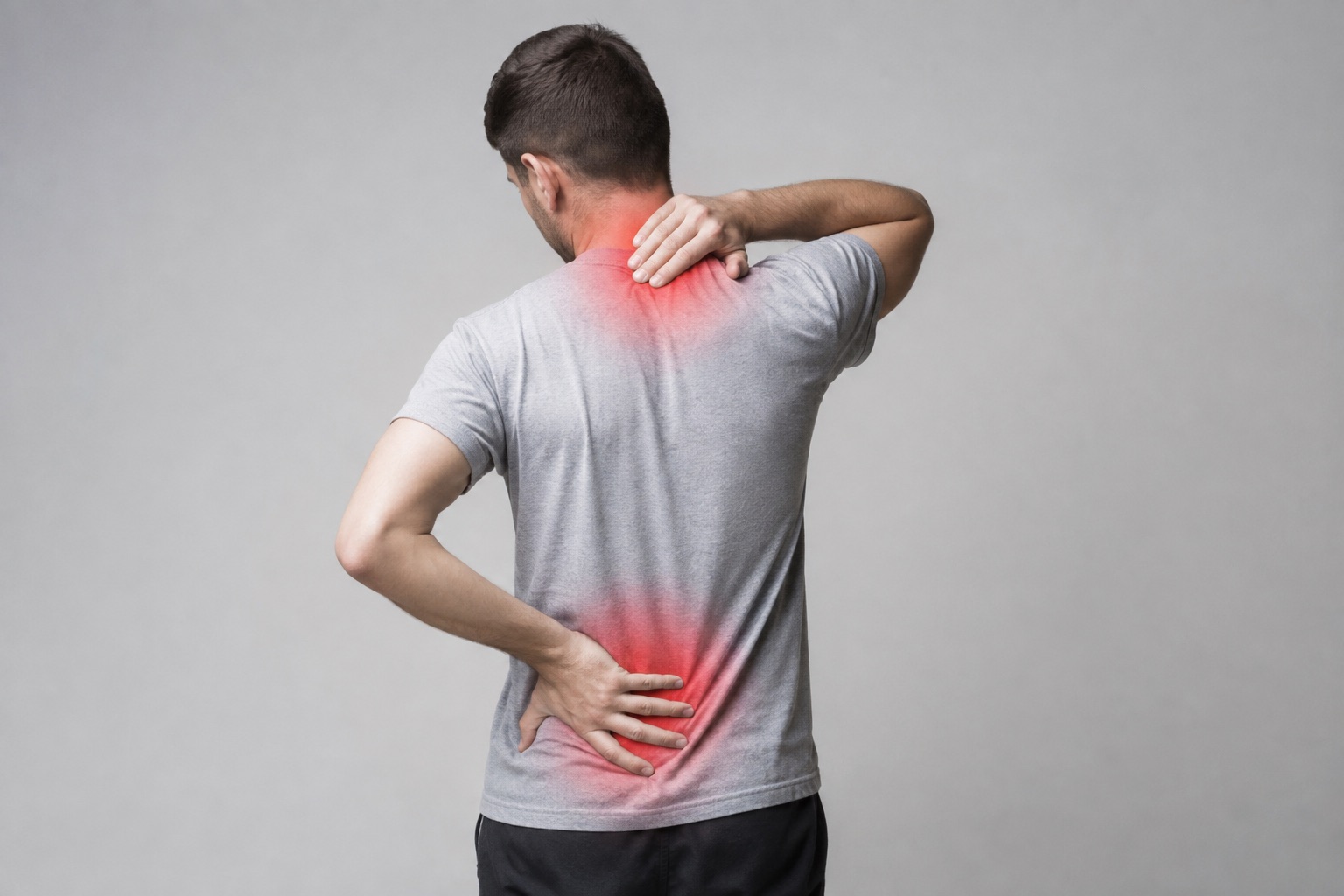 Adult holding their neck and lower back, with highlighted areas of discomfort